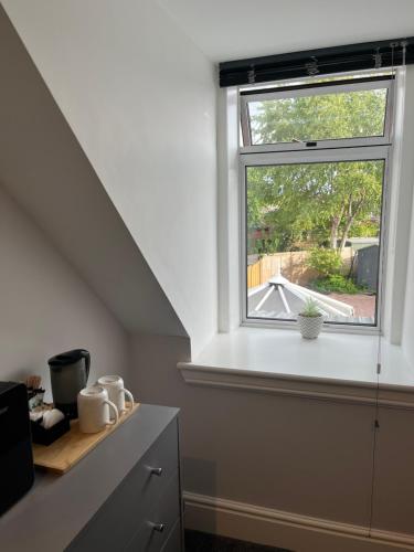 a kitchen with a window and a counter at Fairfield Cottage Rooms in Inverness