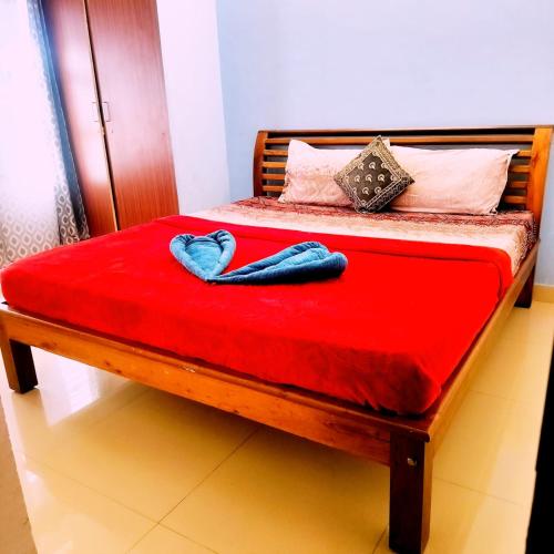 a bed with two blue towels on top of it at Coorg Sunway home stay in Madikeri
