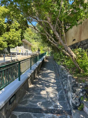 a sidewalk next to a bridge with a tree at Terrace & Parking - Holiday Home near Fegina Beach in Monterosso al Mare