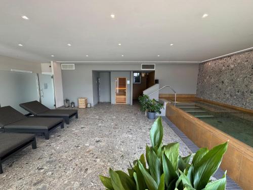 an empty room with a swimming pool and plants at La Dolce Vita Relais - Hotel Gallo in Tignale