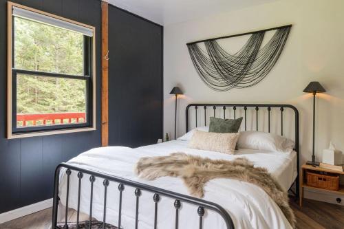 a bedroom with a bed with a furry blanket on it at The Lily Pad - Hunter NY in Elka Park