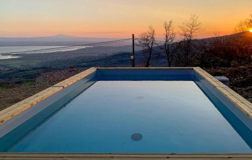 a swimming pool with a sunset in the background at Villa Al Tramonto in Lisciano Niccone