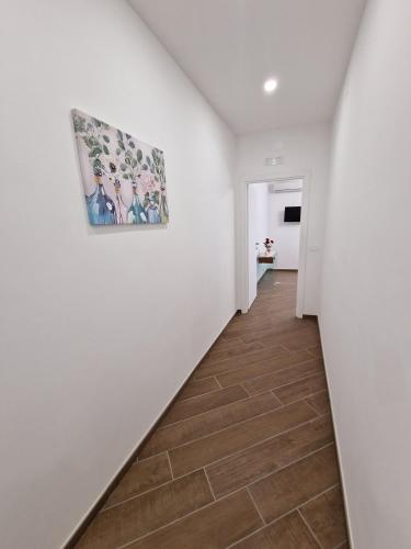 a hallway with white walls and a painting on the wall at Domus Conza in Nocera Inferiore