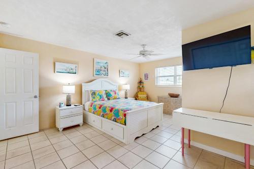 a bedroom with a bed and a desk at Ninth Street Getaway in Key Colony Beach