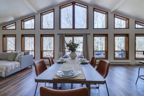 a dining room with a table and chairs and windows at Serene Escape At Big Bass Lake & Pool Access in Clifton