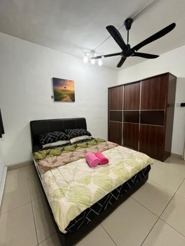 a bedroom with a bed and a ceiling fan at A&M Budget Apt, 5mins to Airport, 8mins to KK City in Penampang