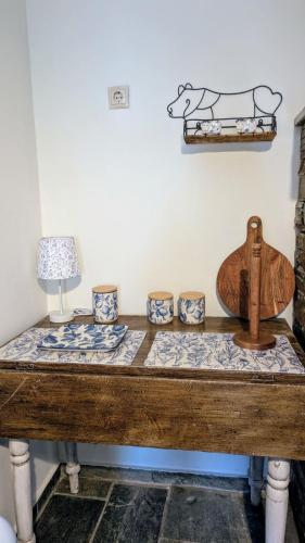 a wooden table with bowls and a wooden cross on top at Stellinas House 2 in Andros