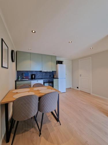 a kitchen and dining room with a table and chairs at Comfortable Apartment Sleeps 4 Near Kristiansand City Center in Kristiansand