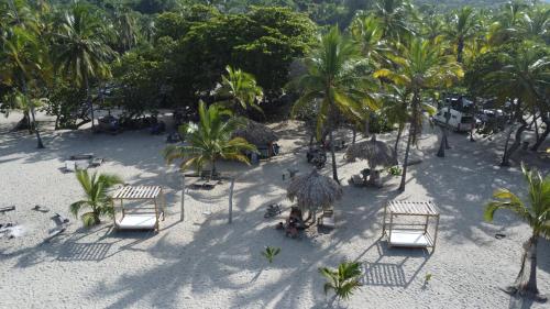 an aerial view of a beach with palm trees at Playas De Casa Grande in Santa Marta