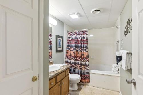 a bathroom with a toilet sink and a shower curtain at WP231 Old Mill Overlook in Pigeon Forge