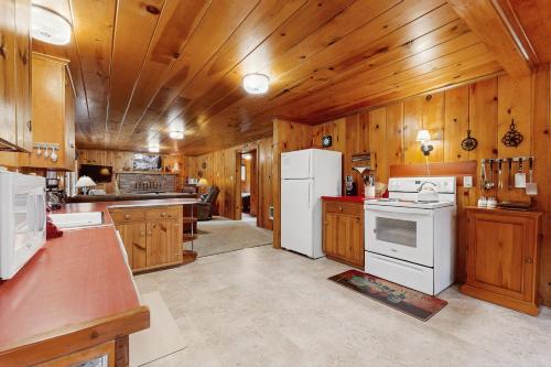 a kitchen with wooden cabinets and white appliances at Forest Dell in Joseph
