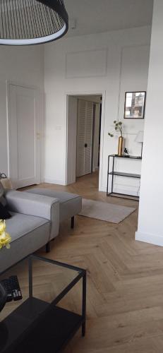 a living room with a couch and a table at LULU Apartament Rynek 3-5 in Grudziądz