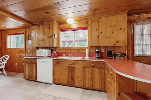 a kitchen with wooden cabinets and a white appliance at Forest Dell in Joseph