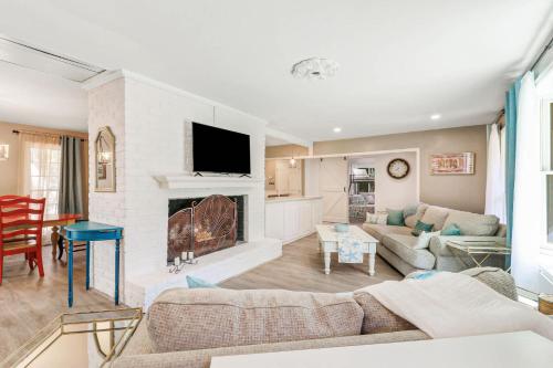a living room with a couch and a fireplace at 1 Block to Ocean Fun in Hilton Head Island