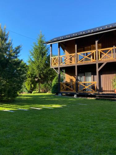 a house with a large yard in front of it at Sita Apartments in Kosiv