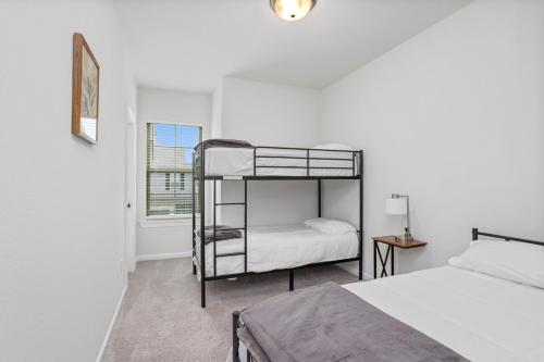 a bedroom with two bunk beds and a window at Stylish Family Townhouse in Baton Rouge - BC1004 in Baton Rouge