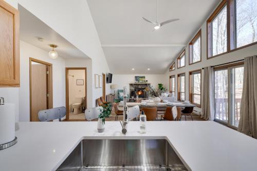 a kitchen with a sink and a dining room at Serene Escape At Big Bass Lake & Pool Access in Clifton