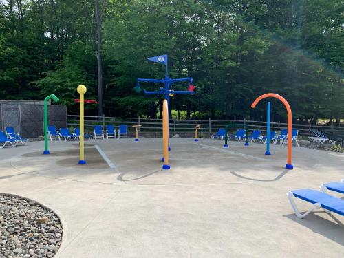 a playground with colorful play equipment in a park at Serene Escape At Big Bass Lake & Pool Access in Clifton