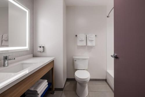a white bathroom with a toilet and a sink at Garner Hotel Londonderry - Manchester by IHG in Londonderry