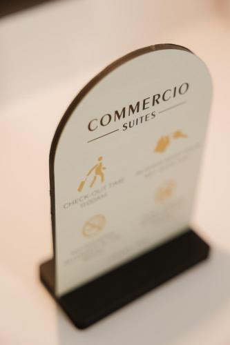 a sign for a comnerico suite at Commercio Suites Santorini in Emporio Santorini