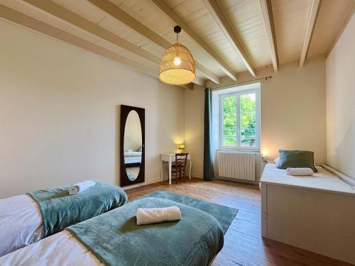 a bedroom with two beds and a large window at Le Clos du Haut Gallion An authentic haven of peace 