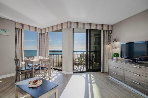 a living room with a view of the ocean at Calming Oceanfront Suite, Dogs OK! 410 in Myrtle Beach