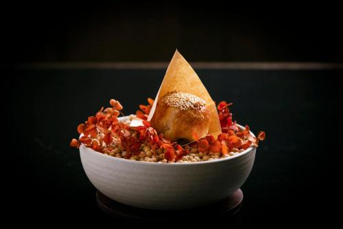 a bowl of food with a tortilla on top ofinoa at Regent Chongqing - Complimentary 1st round mini bar daily in Chongqing