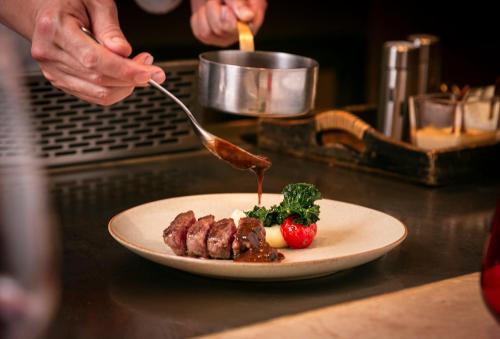a plate of food with meat on a counter at Regent Chongqing - Complimentary 1st round mini bar daily in Chongqing