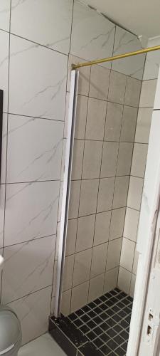 a shower with a black grate in a bathroom at PEACEFUL SLEEP lodge in Goodwood