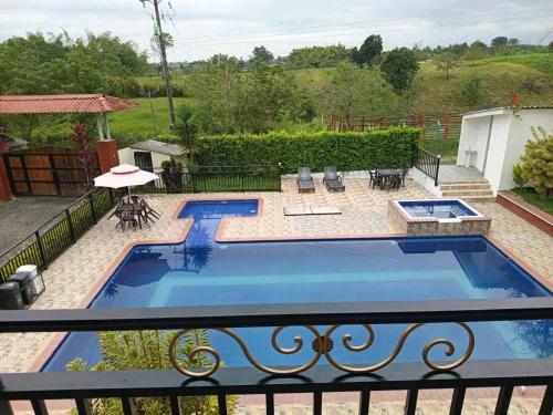 a view of a swimming pool from a balcony at Finca hotel el guadual- QUINDIO-EJE CAFETERO in Quimbaya