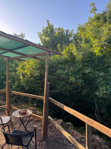 a patio with a table and chairs and a wooden fence at Michalis studio in Zákros