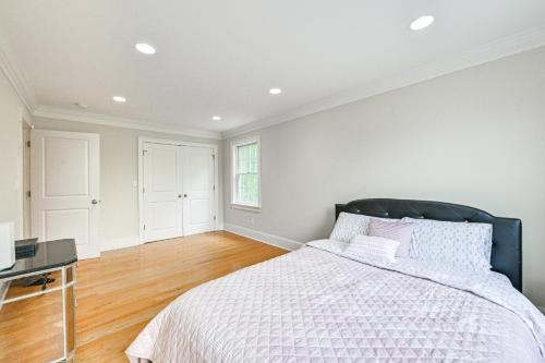 a white bedroom with a bed and a desk at Private Pool and Patio Luxe Westchester Home! in Briarcliff Manor