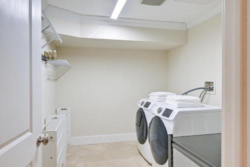 a laundry room with a washer and dryer at Private Pool and Patio Luxe Westchester Home! in Briarcliff Manor