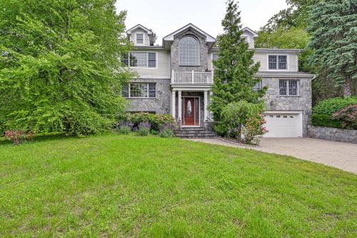 a large house with a green lawn in front of it at Private Pool and Patio Luxe Westchester Home! in Briarcliff Manor