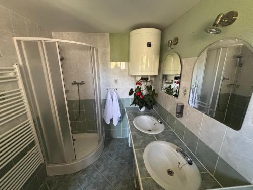 a bathroom with two sinks and a shower at Chata Lipa in Bešeňová