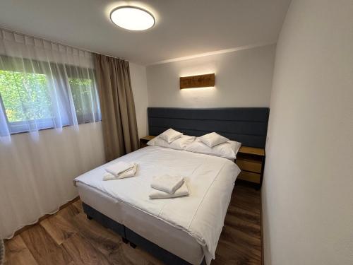 a bedroom with a bed with white pillows on it at Chata Lipa in Bešeňová