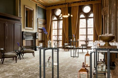 a large room with tables and chairs and windows at St Pancras London, Autograph Collection in London