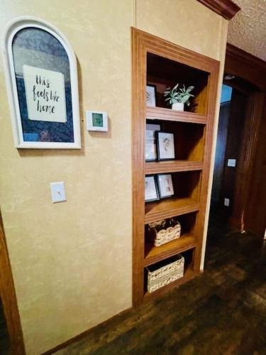 a book shelf in a room with a sign on the wall at Mark House in Hammond