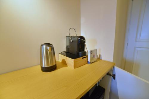 a room with a desk with a coffee maker on it at Rooms in Spello in Spello
