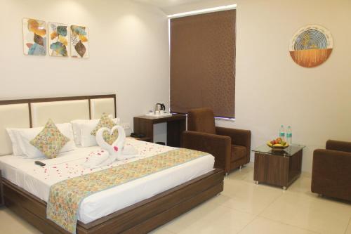 a hotel room with a bed with swans on it at Hotel Annpurna Regency in Sīkar