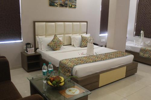 a hotel room with a bed and a table with a bowl of fruit at Hotel Annpurna Regency in Sīkar