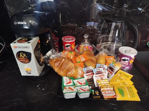a counter top with a bunch of food and a blender at Appartement Luxe & design Vue mer sur la Promenade des Anglais in Nice