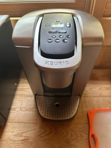 a coffee machine sitting on top of a table at Apple Valley Cabin in Sonora
