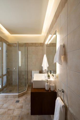 a bathroom with a sink and a shower at The Elite Corfu Luxury Apartment in Corfu