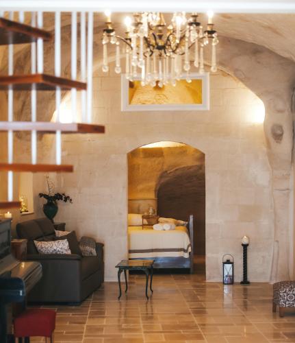 a living room with a couch and a bed at Bellavita Rooms- Isabel luxury Suite in Matera
