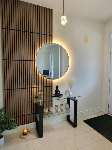a living room with a mirror and a table at Beautiful Family Suites - Master Bedroom in Niagara Falls