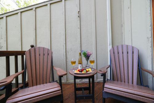 two chairs and a table with two glasses of wine at Mountainview Vista 1 Mile To Water Park & Ski in Tannersville