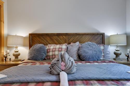 a bed with a person with their feet up on it at Mountainview Vista 1 Mile To Water Park & Ski in Tannersville