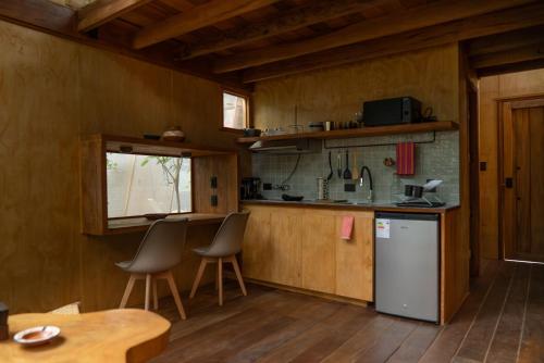 a kitchen with a table and chairs in a room at Tití Bungalows in Tarapoto