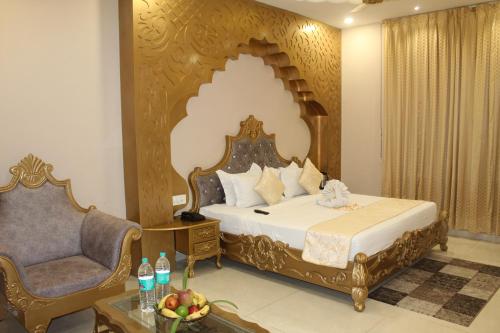 a hotel room with a bed and a chair at Hotel Annpurna Regency in Sīkar